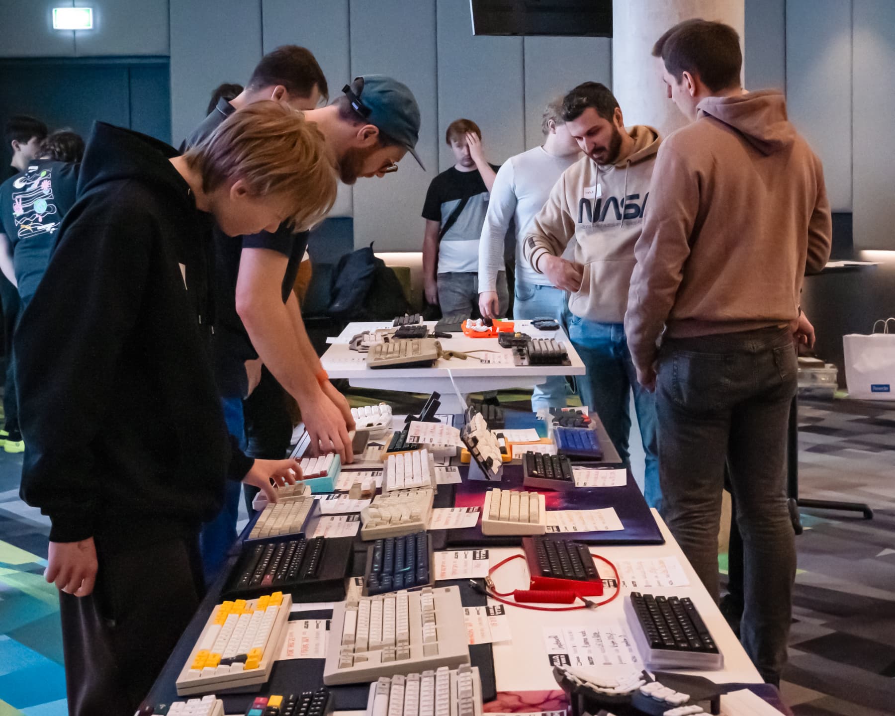 People inspecting keyboards.