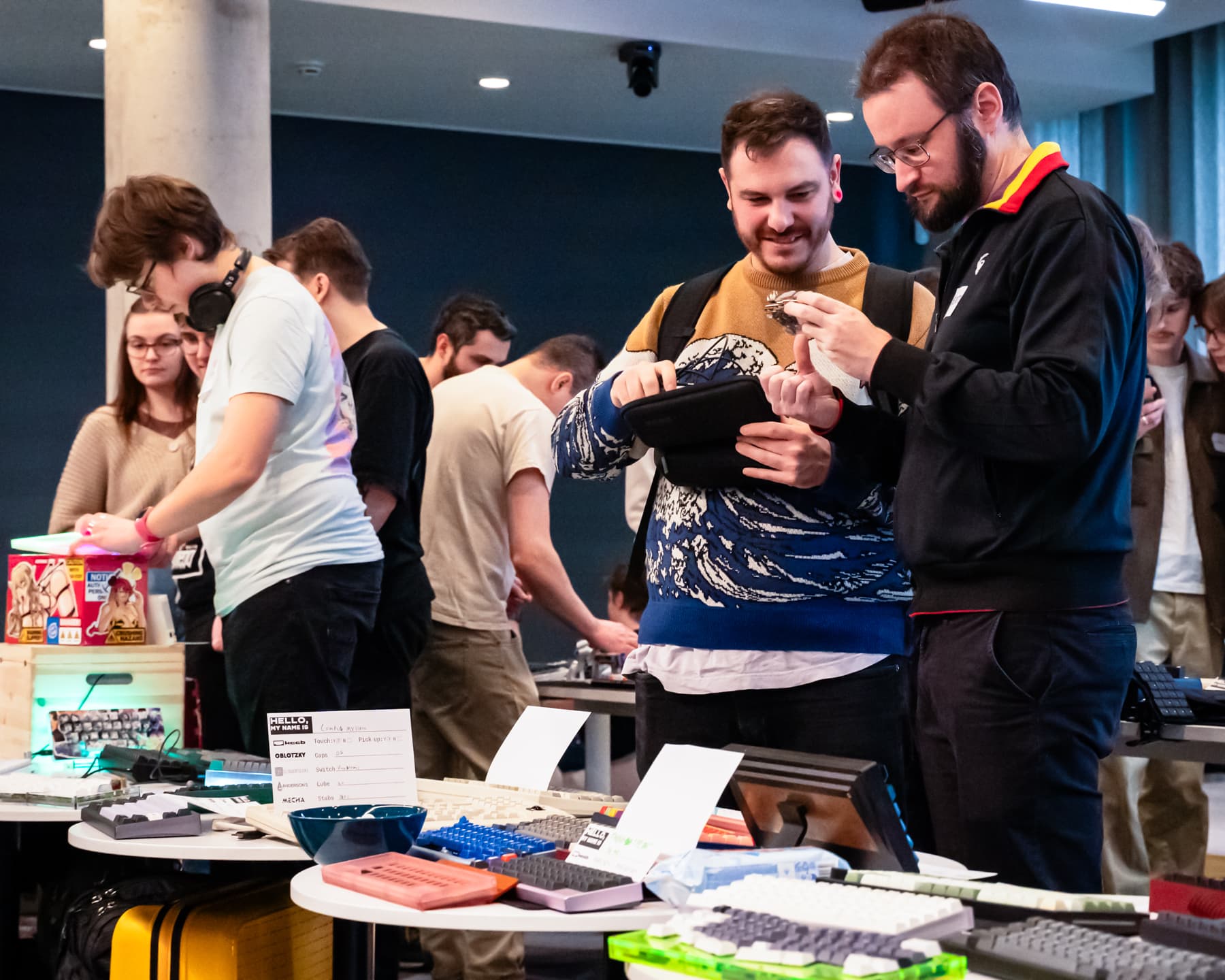 People interacting with each other and keyboards.